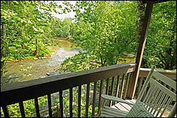 wrap-around porch at Harrison Spring Cabin offers incredible views of Blue River